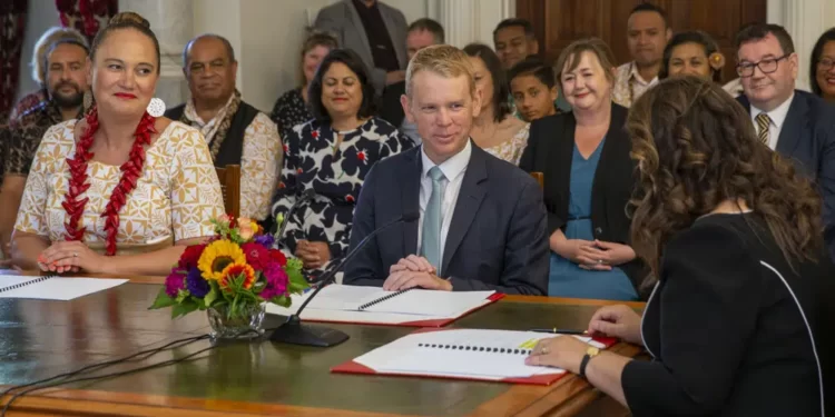 Chris Hipkins, center, is sworn in as New Zealand's next Prime Minister and Carmel Sepuloni, left, as Deputy Prime Minister by Governor-General Dame Cindy Kiro, right, at Government House in Wellington, Wednesday, Jan. 25, 2023