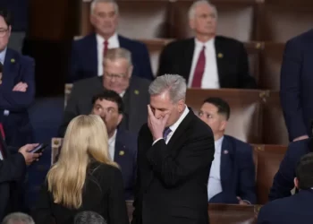 Rep. Kevin McCarthy, R-Calif., talks with Rep. Marjorie Taylor Greene, R-Ga., at the beginning of an evening session after six failed votes to elect a speaker and convene the 118th Congress in Washington, Wednesday, Jan. 4, 2023.