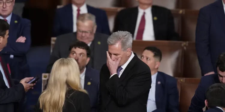 Rep. Kevin McCarthy, R-Calif., talks with Rep. Marjorie Taylor Greene, R-Ga., at the beginning of an evening session after six failed votes to elect a speaker and convene the 118th Congress in Washington, Wednesday, Jan. 4, 2023.