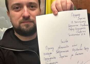 Kyrylo Tymoshenko holds up a note as he tenders his resignation, asking President Volodymyr Zelenskyy to relieve him of his duties, in this picture taken at an unknown location and released on social media on Jan. 24, 2023