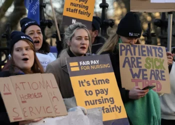 Nurses of the nearby St. Thomas' Hospital stand on the picket line, in London, Monday, Feb. 6, 2023