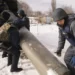 <strong>At Munich Security Conference, Zelenskyy Urges Allies To Quicken Military Support</strong> 12 Ukrainian emergency services employees push the remains of an S-300 missile fired by Russian forces onto a truck in Kharkiv, Ukraine, Friday, Feb. 17, 2023.