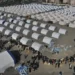 <strong>Turkish Quake Victims Sleep In Trains, Tents, Greenhouses</strong> 15 People who lost their houses in the devastating earthquake, lineup to receive aid supplies at a makeshift camp, in Iskenderun city, southern Turkey