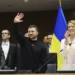 Ukraine's President Volodymyr Zelenskyy, centre, gestures as European Parliament's President Roberta Metsola, right, applauds during an EU summit at the European Parliament in Brussels, Belgium, Thursday, Feb. 9, 2023.