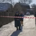 Residents wait behind police cordon to return to their homes after a rocket attack in Kyiv suburbs, Ukraine, Friday, Feb. 10, 2023.