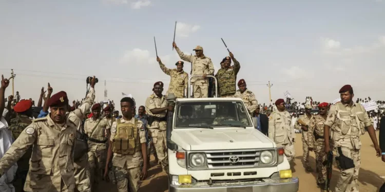 Gen. Mohammed Hamdan Dagalo, the deputy head of the military council, waves to a crowd during a military-backed tribe's rally, in the Nile River State, Sudan, Saturday, on July 13, 2019.