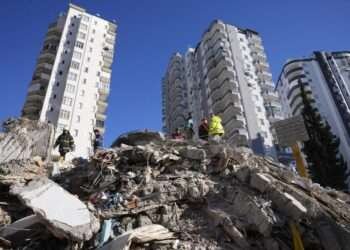 Emergency teams search for people in the rubble of a destroyed building in Adana, southern Turkey, Tuesday, Feb. 7, 2023