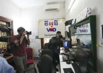 Journalists take photographs at a newsroom of the Voice of Democracy, VOD office in Phnom Penh, Cambodia