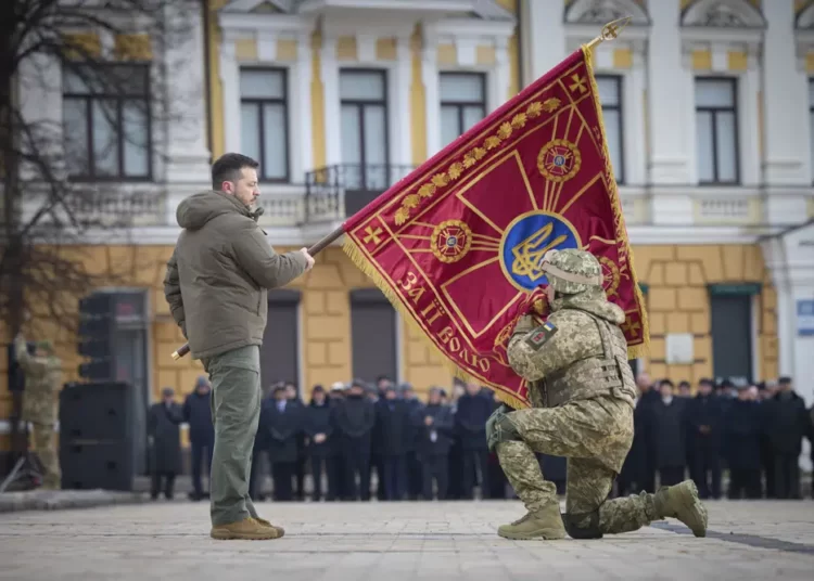<strong>Zelenskyy Vows To Strive For Victory On War Anniversary</strong> 1 Ukrainian President Volodymyr Zelenskyy, left, holds the flag of a military unit as an officer kisses it, during commemorative event on the occasion of the Russia Ukraine war one year anniversary in Kyiv, Ukraine, Friday, Feb. 24, 2023.