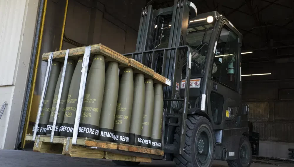 Airmen with the 436th Aerial Port Squadron use a forklift to move 155 mm shells ultimately bound for Ukraine, April 29, 2022, at Dover Air Force Base, Del.