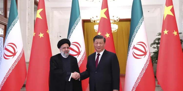 President Ebrahim Raisi, left, shakes hands with his Chinese counterpart Xi Jinping in an official welcoming ceremony in Beijing