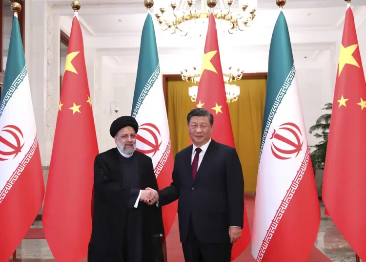 President Ebrahim Raisi, left, shakes hands with his Chinese counterpart Xi Jinping in an official welcoming ceremony in Beijing