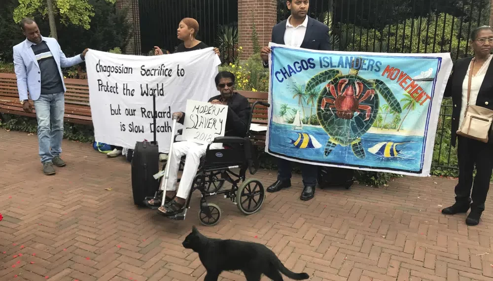 Protesters hold banners outside the World Court in The Hague, Netherlands, on Sept. 3, 2018, where judges listen to arguments in a case on whether Britain illegally maintains sovereignty over the Chagos Islands.