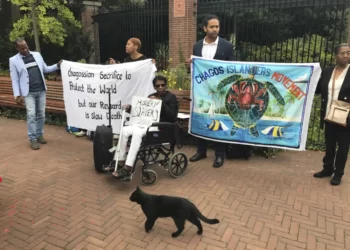 Protesters hold banners outside the World Court in The Hague, Netherlands, on Sept. 3, 2018, where judges listen to arguments in a case on whether Britain illegally maintains sovereignty over the Chagos Islands.