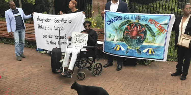 Protesters hold banners outside the World Court in The Hague, Netherlands, on Sept. 3, 2018, where judges listen to arguments in a case on whether Britain illegally maintains sovereignty over the Chagos Islands.