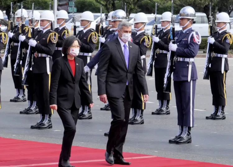 Taiwan's President Tsai Ing-wen, left, and Paraguay's President Mario Abdo Benitez walk past an honor guard at the Presidential House in Taipei, Taiwan, Thursday, Feb. 16, 2023.