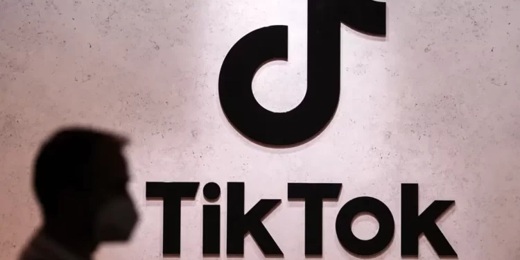 A visitor passes the TikTok exhibition stands at the Gamescom computer gaming fair in Cologne, Germany, Thursday, Aug. 25, 2022.