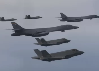 In this photo provided by South Korean Defense Ministry, U.S. Air Force B-1B bombers, center, F-22 fighter jets and South Korean Air Force F-35 fighter jets, bottom, fly over South Korea Peninsula during a joint air drill in South Korea, on Jan. 1, 2023