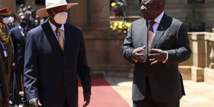 Ugandan President Yoweri Museveni, left, and his South African counterpart Cyril Ramaphosa meet during a welcoming ceremony in Pretoria, South Africa, Tuesday, Feb. 28, 2023.