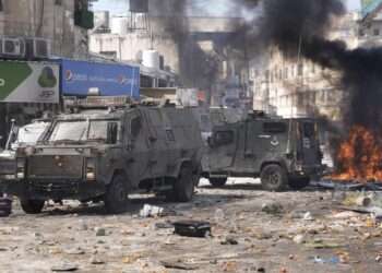 Smoke from fires fills the air as Palestinians clash with Israeli forces in the West Bank city of Nablus