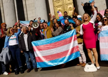Spain's Minister for Equality Irene Montero, centre, celebrates the final approval of a law that will make it easier for people to self-identify as transgender, with LGBTQ activists outside Spain's Parliament in Madrid, Spain