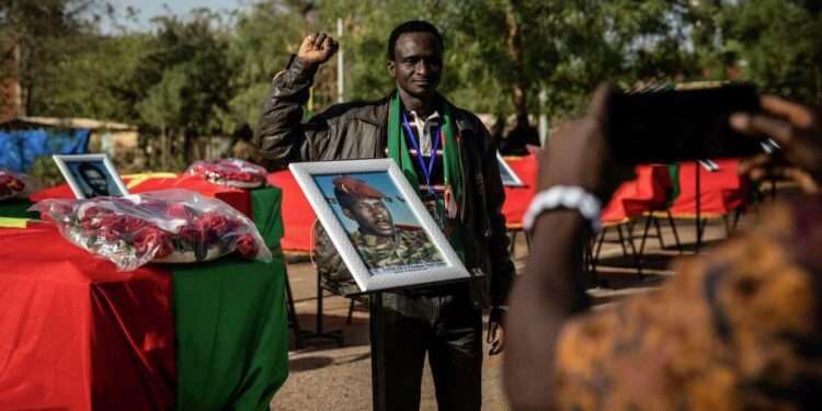 <strong>Burkina Faso Reburies Former Leader Sankara</strong> 1 A man poses for a picture as he stands next to the coffin containing the remains of Burkina Faso's revolutionary leader, Thomas Sankara, during his reburial ceremony in Ouagadougou, Burkina Faso, Thursday, Feb. 23, 2023.