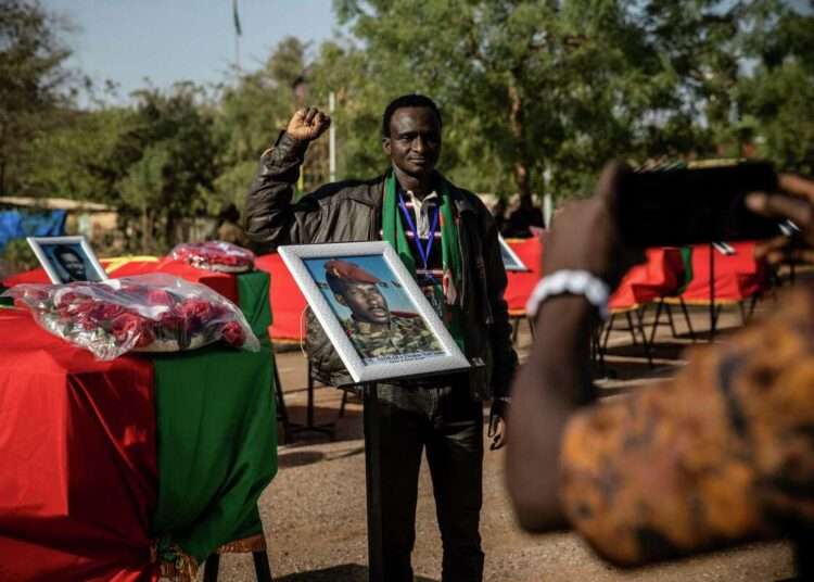 <strong>Burkina Faso Reburies Former Leader Sankara</strong> 1 A man poses for a picture as he stands next to the coffin containing the remains of Burkina Faso's revolutionary leader, Thomas Sankara, during his reburial ceremony in Ouagadougou, Burkina Faso, Thursday, Feb. 23, 2023.
