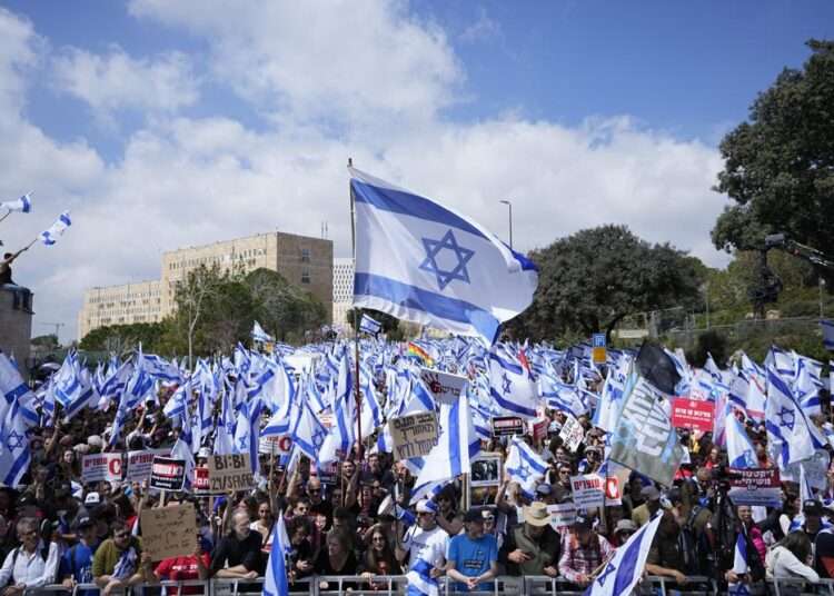 Mass Strikes, Protests Mount Pressure On Netanyahu Over Judiciary Reform Plan 1 Israelis protest against Prime Minister Benjamin Netanyahu's judicial overhaul plan outside the parliament in Jerusalem, Monday, March 27, 2023.