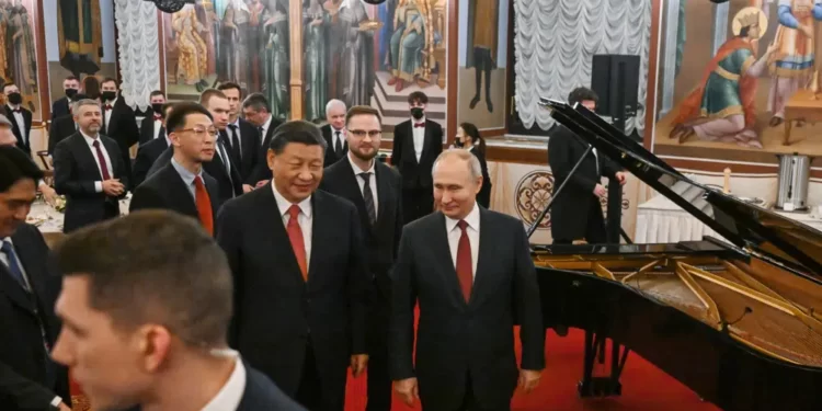 Chinese President Xi Jinping, center left, and Russian President Vladimir Putin, right, walk after their dinner at The Palace of the Facets in the Moscow Kremlin, Russia, Tuesday, March 21, 2023.
