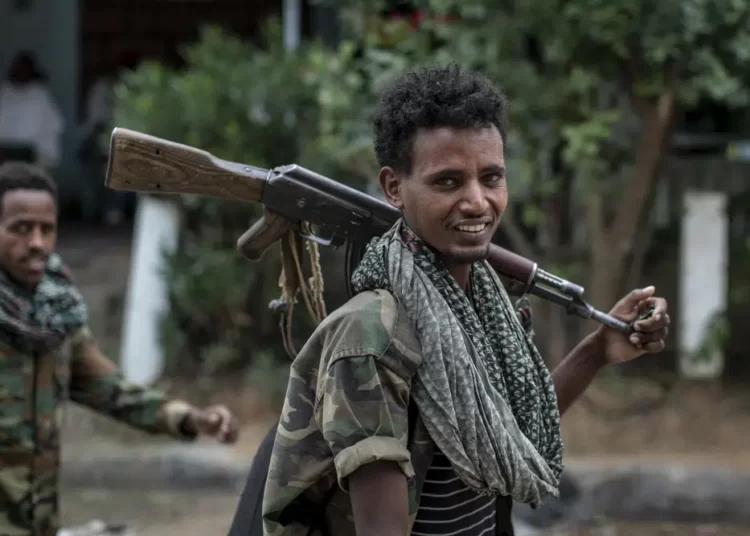 Fighters loyal to the Tigray People's Liberation Front (TPLF) walk along a street in the town of Hawzen, then controlled by the group, in the Tigray region of northern Ethiopia on May 7, 2021.