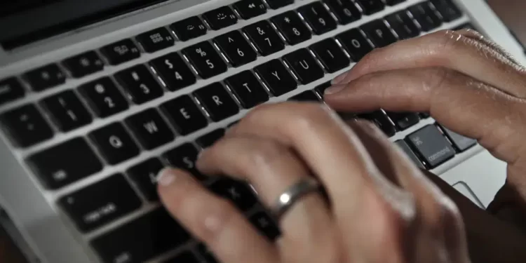U.S To Adopt New Restrictions On Using Commercial Spyware 1 A person types on a laptop keyboard