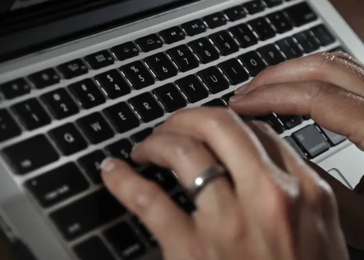 U.S To Adopt New Restrictions On Using Commercial Spyware 1 A person types on a laptop keyboard