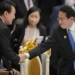 Japan's Prime Minister Fumio Kishida, right, shakes hands with South Korea's President Yoon Suk Yeol during the ASEAN - East Asia Summit in Phnom Penh, Cambodia, on Nov. 13, 2022