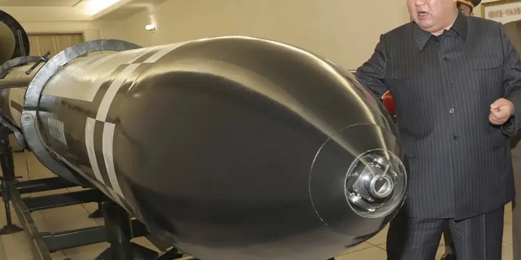 This photo provided on Tuesday, March 28, 2023, by the North Korean government, North Korean leader Kim Jong Un, rear, visits a hall displayed what appeared to be various types of warheads designed to be mounted on missiles or rocket launchers.