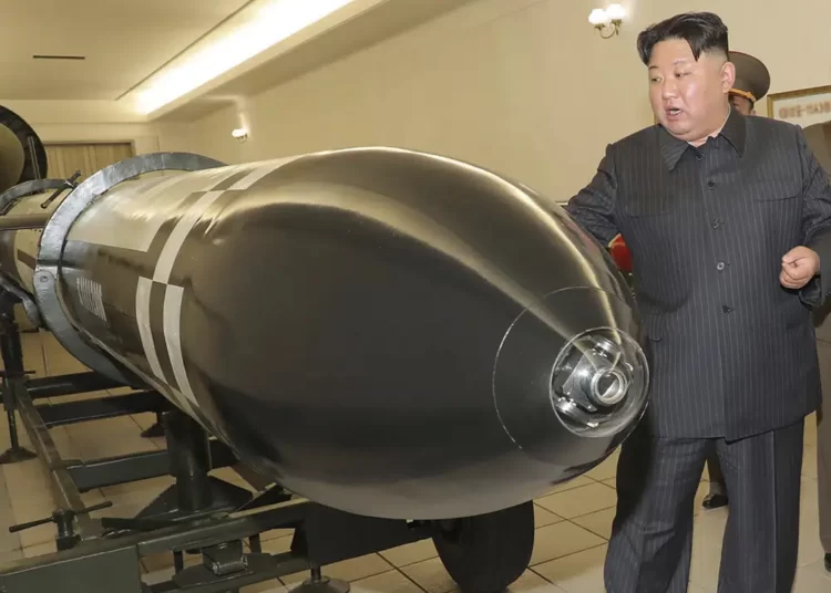 This photo provided on Tuesday, March 28, 2023, by the North Korean government, North Korean leader Kim Jong Un, rear, visits a hall displayed what appeared to be various types of warheads designed to be mounted on missiles or rocket launchers.
