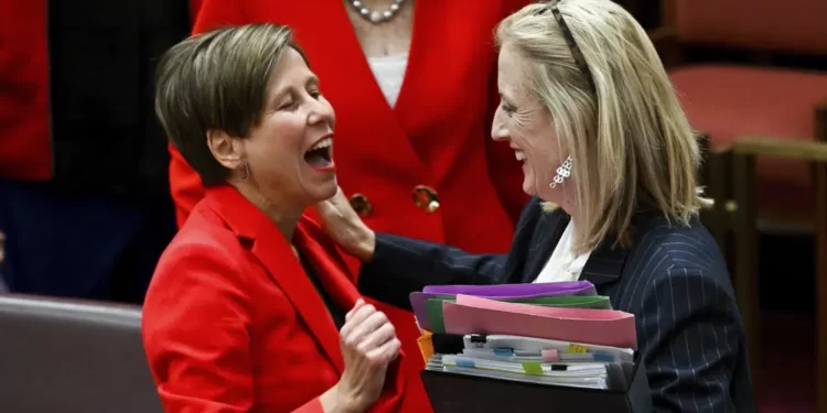 Australia Creates Laws To Curb Carbon Emissions 1 Australian Finance Minister Katy Gallagher, right, and Assistant Minister for Climate Change Jenny MacAllister react after the passing of the Safeguard Mechanism bill in the Senate chamber at Parliament House in Canberra, Thursday, March 30, 2023.