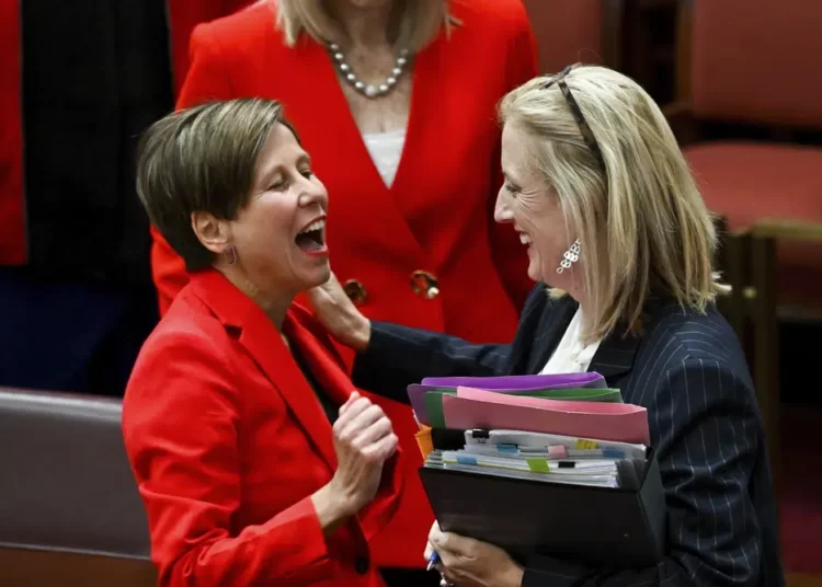 Australia Creates Laws To Curb Carbon Emissions 1 Australian Finance Minister Katy Gallagher, right, and Assistant Minister for Climate Change Jenny MacAllister react after the passing of the Safeguard Mechanism bill in the Senate chamber at Parliament House in Canberra, Thursday, March 30, 2023.