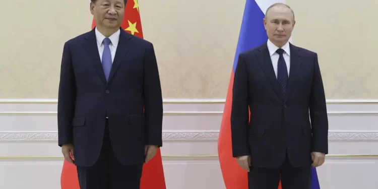 Xi Jinping To Visit Russia Next Week 1 Chinese President Xi Jinping, left, and Russian President Vladimir Putin pose for a photo on the sidelines of the Shanghai Cooperation Organisation (SCO) summit in Samarkand, Uzbekistan