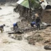 Men salvage parts from their destroyed home, following heavy rains caused by Cyclone Freddy in Blantyre, southern Malawi, Wednesday, March 15, 2023.