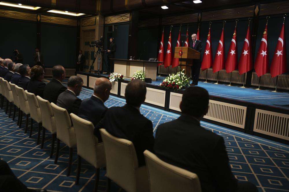 Ministers and his ruling party officials listen as Turkeys President Recep Tayyip Erdogan speaks
