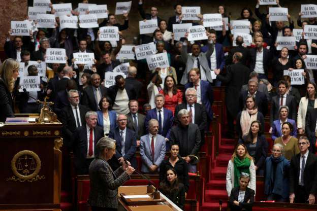 Opposition politicians held up signs protesting the plans to raise the pension age and sang La Marseillaise the French national anthem