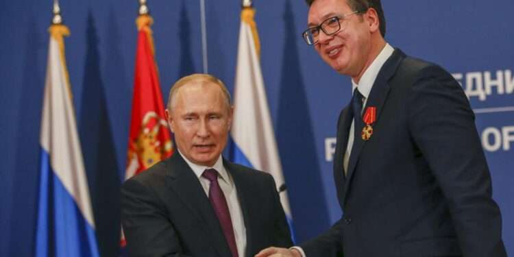 Russian President Vladimir Putin, left, shakes hands with Serbian President Aleksandar Vucic after being awarded the Order of Alexander Nevsky in Belgrade, Serbia, Thursday, Jan. 17, 2019.