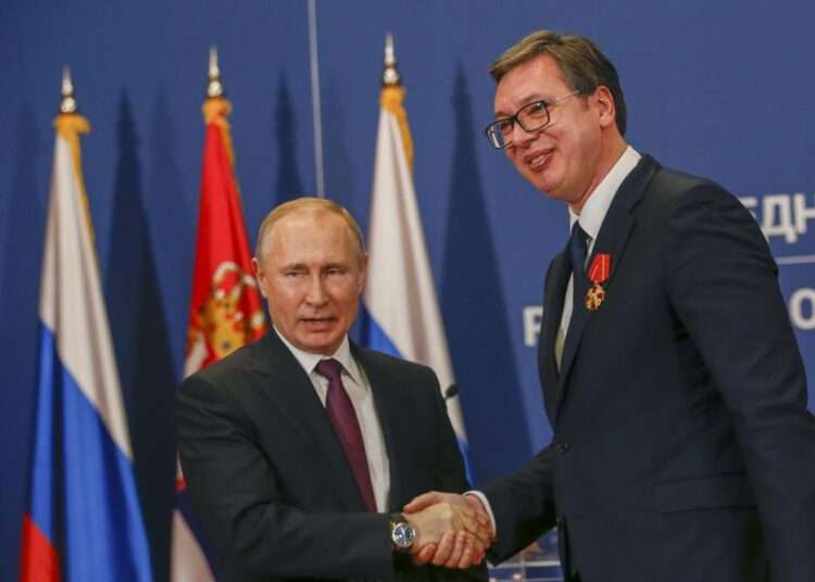 Russian President Vladimir Putin, left, shakes hands with Serbian President Aleksandar Vucic after being awarded the Order of Alexander Nevsky in Belgrade, Serbia, Thursday, Jan. 17, 2019.