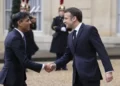 French President Emmanuel Macron, right, shares hands with Britain's Prime Minister Rishi Sunak Friday, March 10, 2023 at the Elysee Palace in Paris.