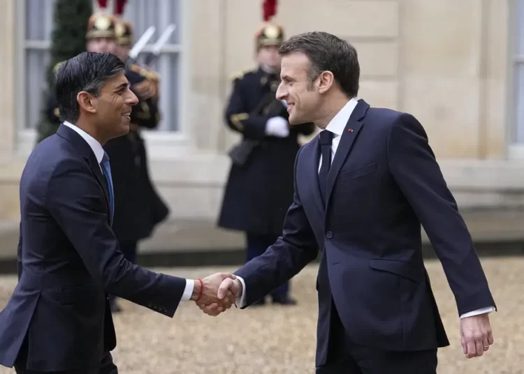 French President Emmanuel Macron, right, shares hands with Britain's Prime Minister Rishi Sunak Friday, March 10, 2023 at the Elysee Palace in Paris.