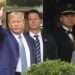 Former President Donald Trump, left, gestures as he leaves Trump Tower in New York, Thursday, April 13, 2023.