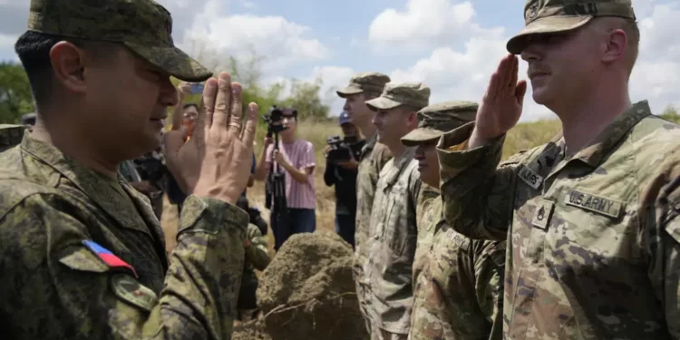 Philippines Names 4 New Camps For U.S Forces 1 Philippine Army Artillery Regiment Commander Anthony Coronel, left, returns a salute from a US soldier during a joint military drill called Salaknib at Laur, Nueva Ecija province, northern Philippines on Friday, March 31, 2023.