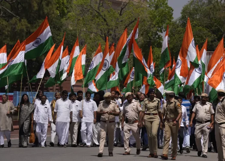 Indian Opposition Lawmakers Protest Against Modi Government 1 Opposition Lawmakers carry big national flag take out a protest march from Indian Parliament House, in New Delhi, India, Thursday, April 6, 2023.