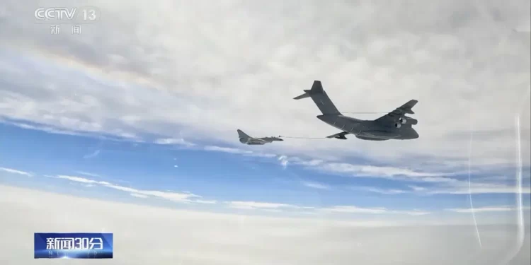 In this image taken from video footage run Saturday, April 8, 2023 by China's CCTV, a Chinese fighter jet performs an mid-air refueling maneuver at an unspecified location.