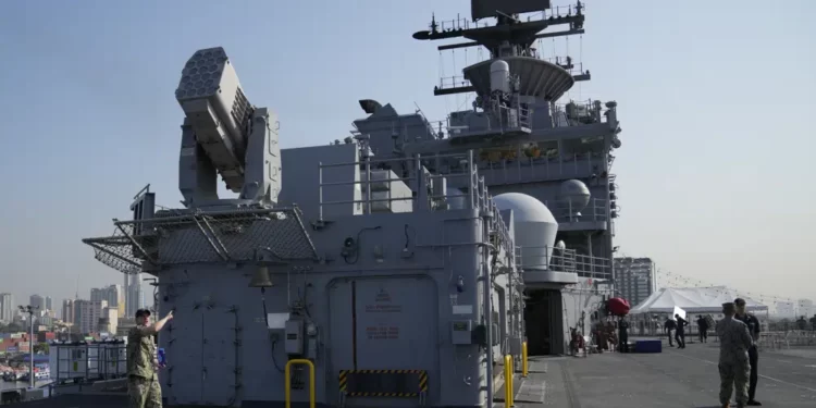 A U.S. Marines personnel gestures at the flight deck of the USS America (LHA 6) during a scheduled port visit in Manila, Philippines on Tuesday, March 21, 2023.
